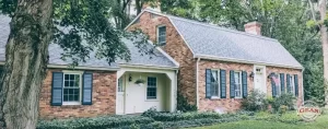 Brick Home with new roof courtesy of Gean Roofing. Gean Roofing Watermark in bottom right corner.