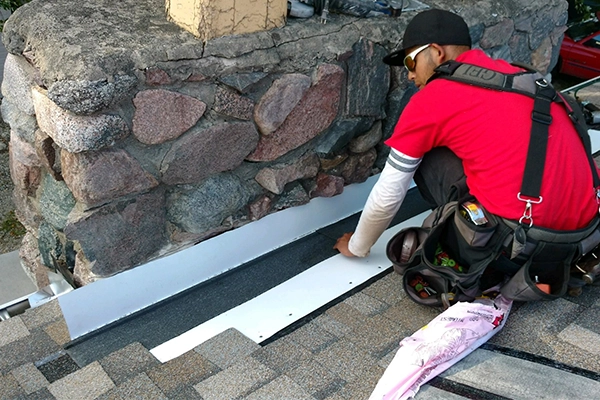 Gean Roofing team member performing a roof repair on a  residential home